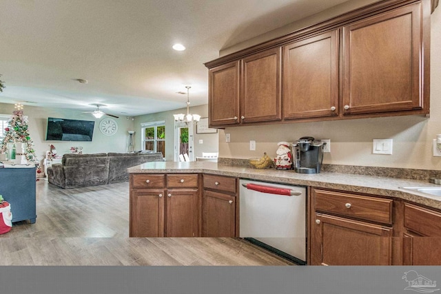 kitchen with dishwasher, decorative light fixtures, ceiling fan with notable chandelier, and light hardwood / wood-style flooring