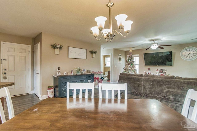 dining room featuring a textured ceiling, dark wood-type flooring, and ceiling fan with notable chandelier