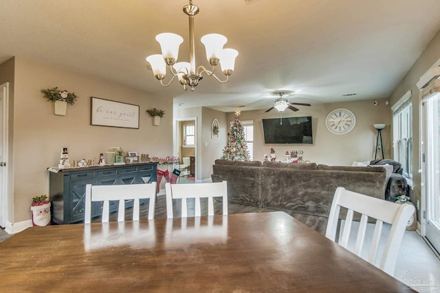 dining area with plenty of natural light and ceiling fan with notable chandelier