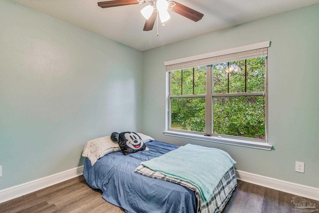 bedroom with ceiling fan and dark wood-type flooring