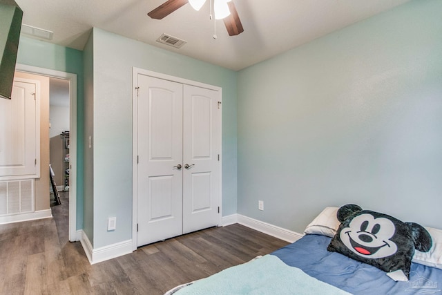 bedroom with a closet, ceiling fan, and dark hardwood / wood-style flooring