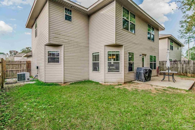 back of house featuring a yard, a patio, and central air condition unit