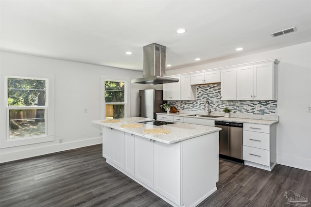 kitchen featuring stainless steel appliances, dark hardwood / wood-style flooring, island exhaust hood, and a healthy amount of sunlight