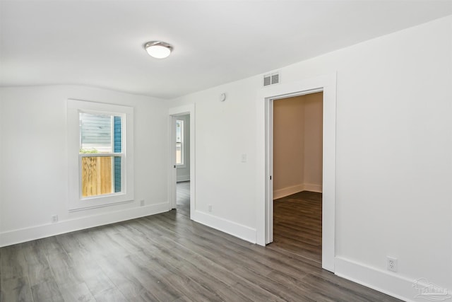 empty room featuring dark hardwood / wood-style flooring