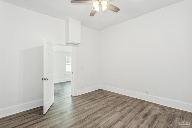 empty room with hardwood / wood-style floors and ceiling fan