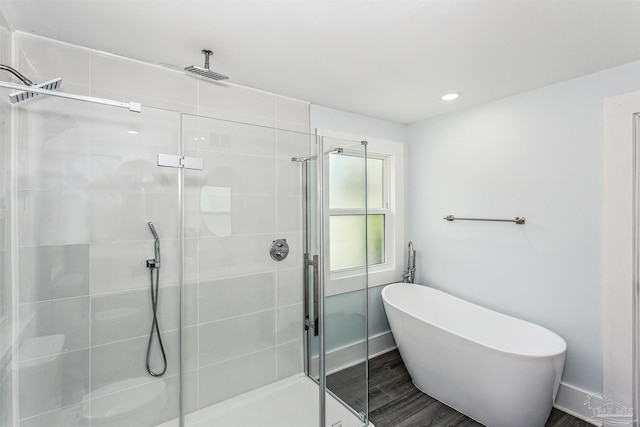 bathroom featuring separate shower and tub and hardwood / wood-style flooring