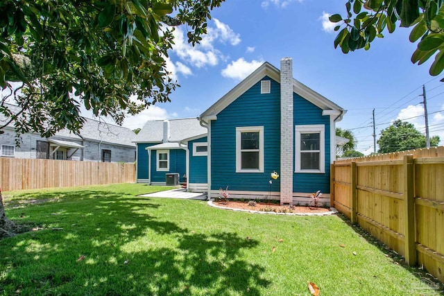 exterior space featuring central AC and a yard