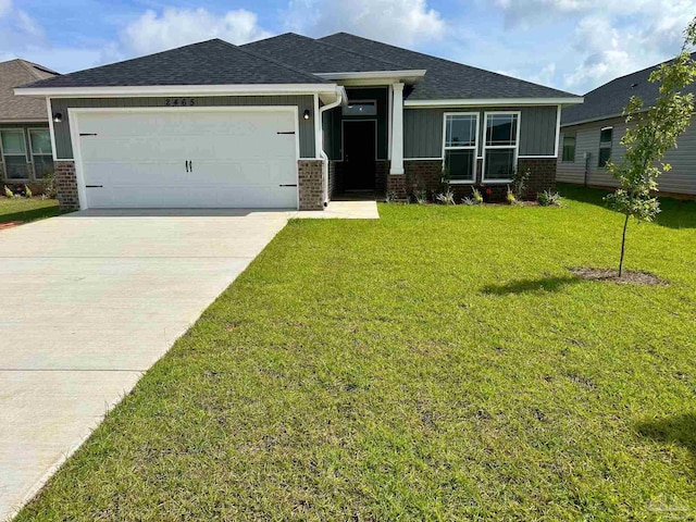 view of front of property with a front yard, brick siding, a shingled roof, board and batten siding, and an attached garage