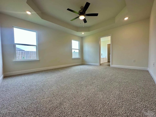 carpeted empty room with baseboards, ceiling fan, recessed lighting, and a raised ceiling