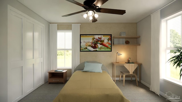 carpeted bedroom featuring a closet and ceiling fan