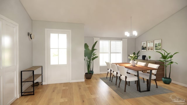 dining room featuring vaulted ceiling, a wealth of natural light, light wood-type flooring, and an inviting chandelier