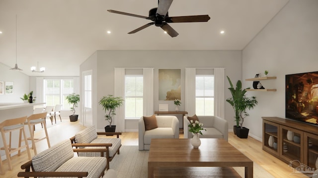 living room featuring ceiling fan, a wealth of natural light, and light wood-type flooring