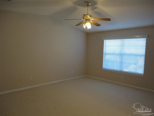 carpeted spare room with ceiling fan and lofted ceiling