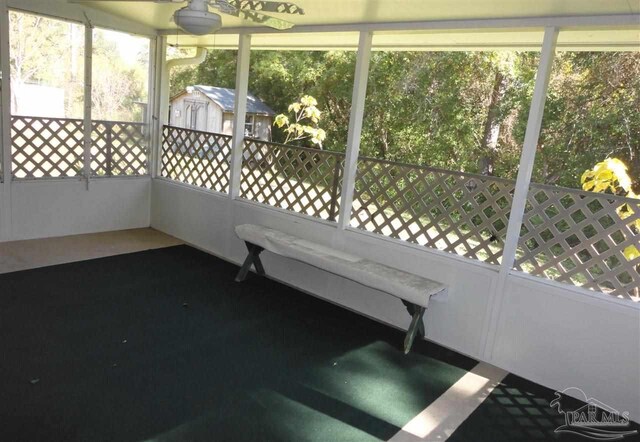 carpeted empty room featuring a healthy amount of sunlight and a textured ceiling