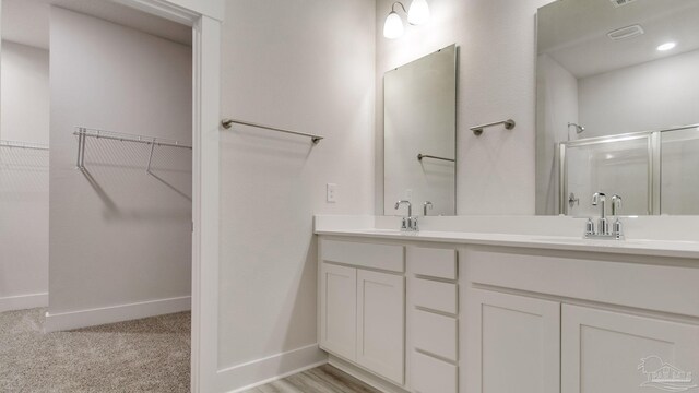 2733 Chevy Cir, Pace, FL 32571 - full bath with a shower stall, baseboards, double vanity, and a walk in closet