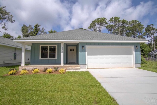 ranch-style home featuring covered porch, a garage, and a front lawn