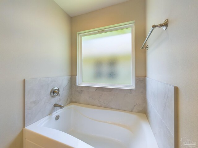 bathroom featuring a washtub and a wealth of natural light