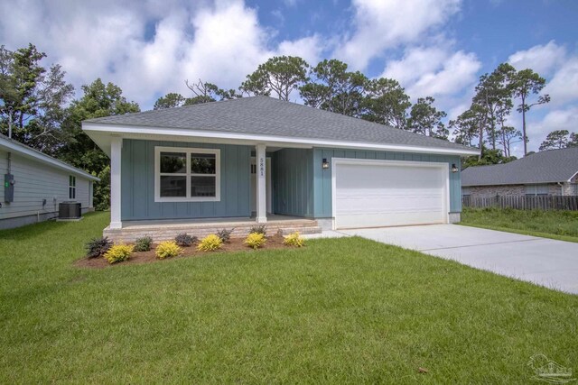 view of front facade featuring a porch, a garage, central AC unit, and a front yard