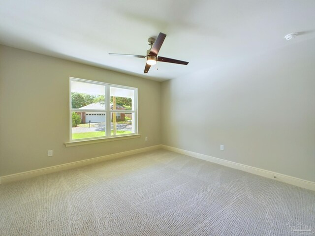 unfurnished room featuring light carpet and ceiling fan