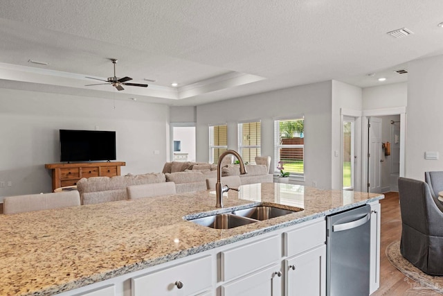 3416 Southwind Dr, Gulf Breeze, FL 32563 - kitchen with a sink, stainless steel dishwasher, open floor plan, light wood-style flooring, and a textured ceiling
