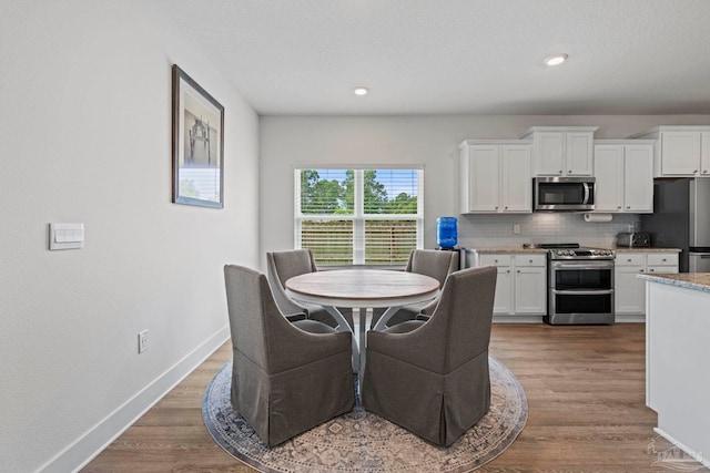 3416 Southwind Dr, Gulf Breeze, FL 32563 - dining room featuring wood finished floors, baseboards, and recessed lighting
