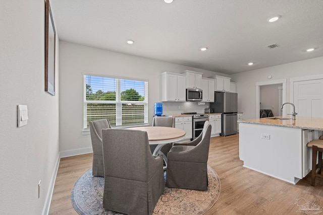 3416 Southwind Dr, Gulf Breeze, FL 32563 - dining area featuring light wood-style floors, baseboards, and recessed lighting