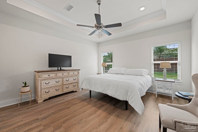 3416 Southwind Dr, Gulf Breeze, FL 32563 - bedroom with a tray ceiling, wood finished floors, multiple windows, recessed lighting, and a ceiling fan