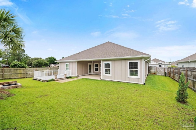 3416 Southwind Dr, Gulf Breeze, FL 32563 - rear view of house featuring board and batten siding, a shingled roof, a wooden deck, and a patio area