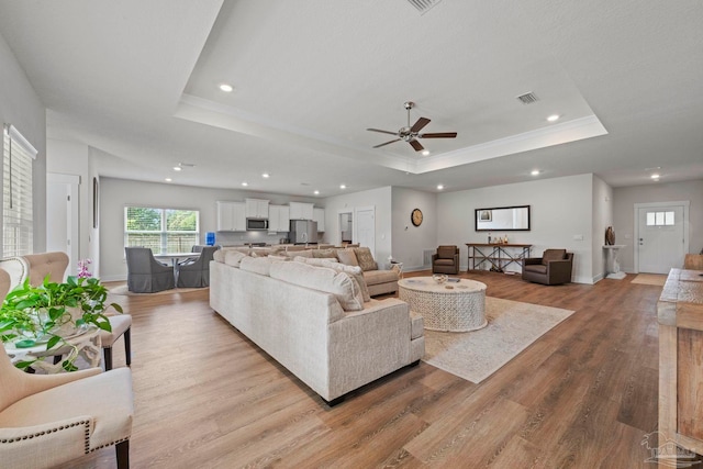 3416 Southwind Dr, Gulf Breeze, FL 32563 - living area with a raised ceiling, light wood-style flooring, a ceiling fan, plenty of natural light, and recessed lighting