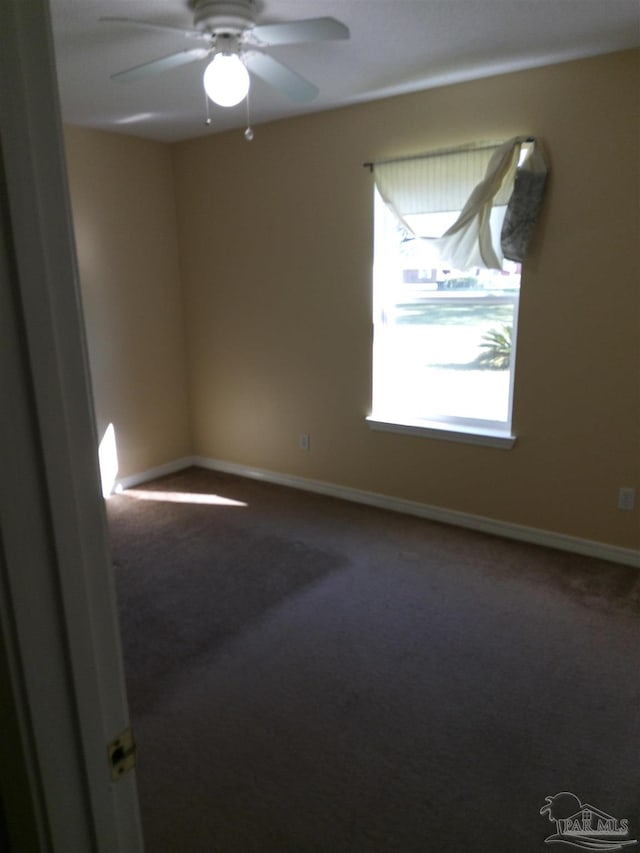 spare room featuring carpet and ceiling fan