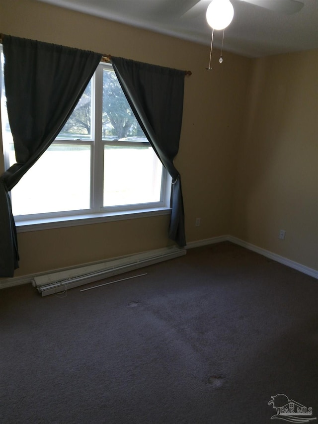 spare room featuring ceiling fan and carpet floors