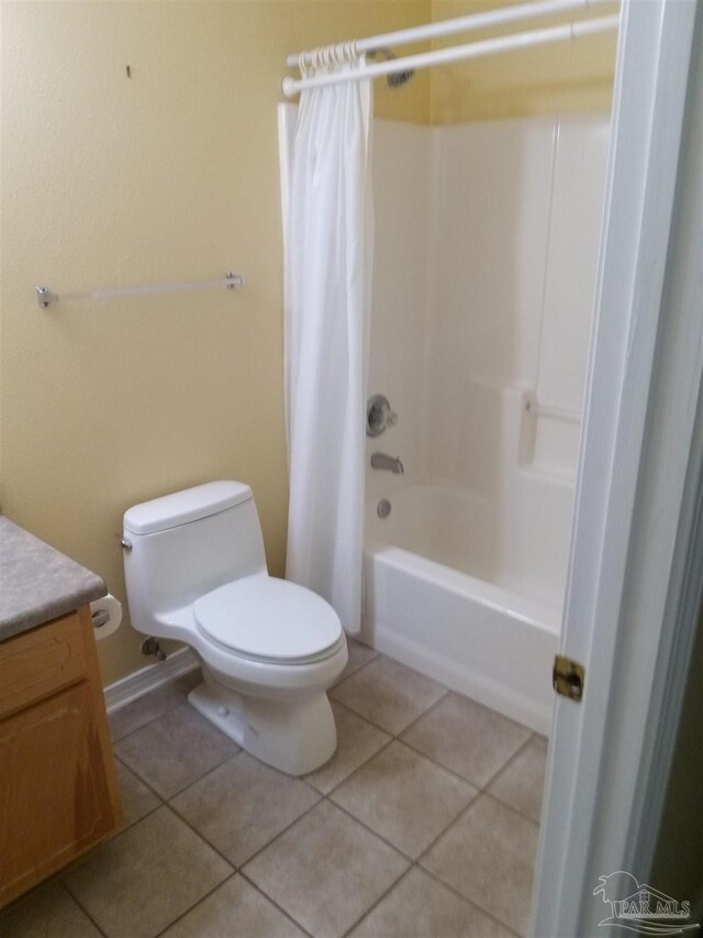 full bathroom with shower / tub combo, tile patterned floors, vanity, and toilet