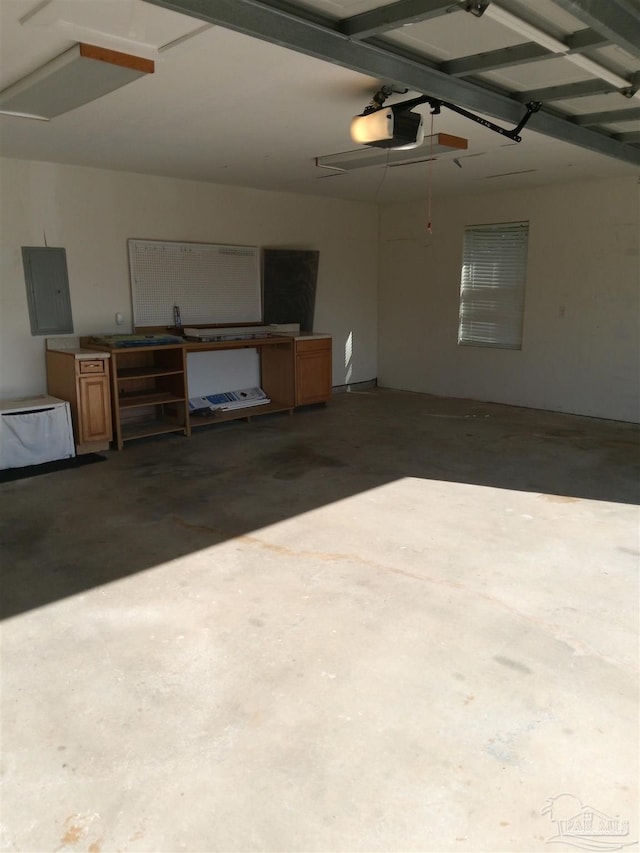 garage with a garage door opener and electric panel