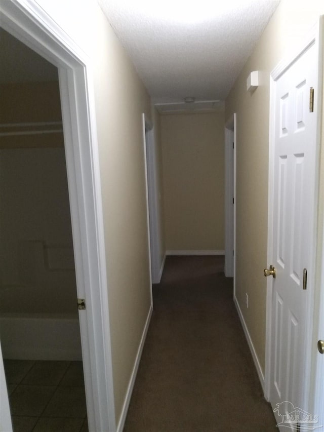 corridor with dark tile patterned floors