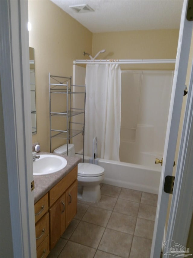 full bathroom featuring shower / bath combo, tile patterned flooring, vanity, and toilet