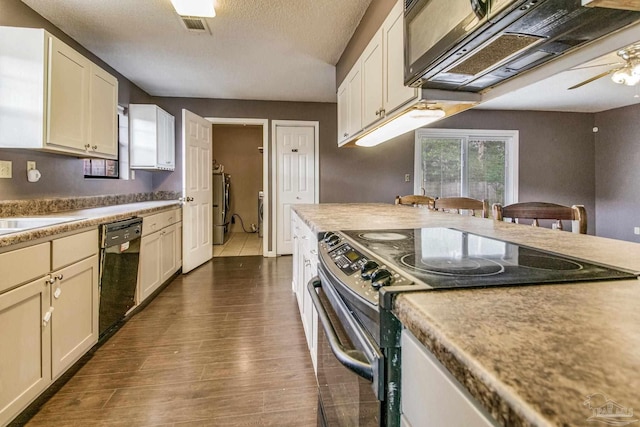 kitchen featuring washer / dryer, stainless steel range with electric stovetop, dark hardwood / wood-style floors, dishwasher, and ceiling fan