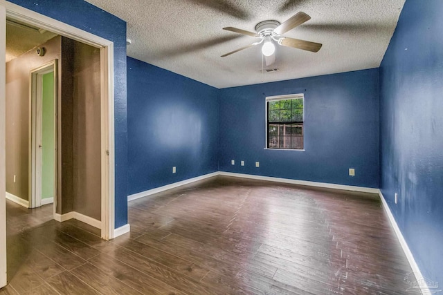 spare room featuring ceiling fan, a textured ceiling, and dark hardwood / wood-style flooring