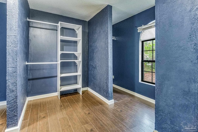 interior space with hardwood / wood-style floors and a textured ceiling