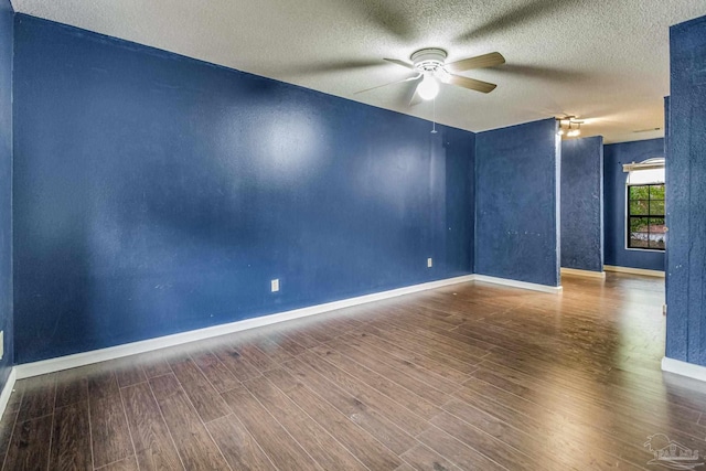 spare room featuring hardwood / wood-style flooring, ceiling fan, and a textured ceiling