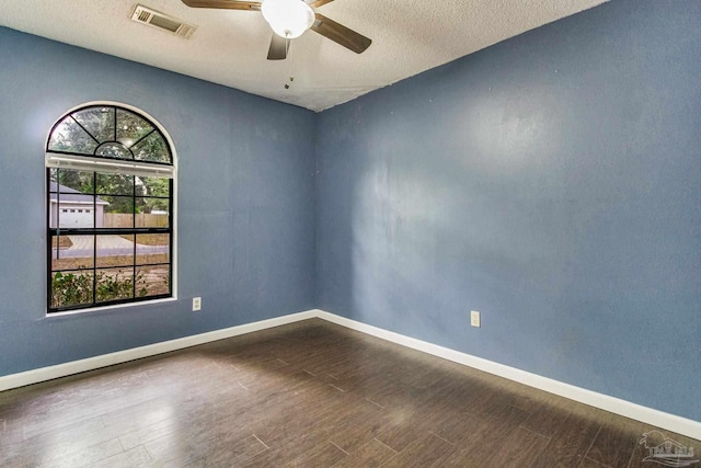 spare room featuring hardwood / wood-style flooring, a textured ceiling, and ceiling fan