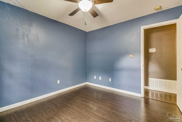 spare room with a textured ceiling, wood-type flooring, and ceiling fan