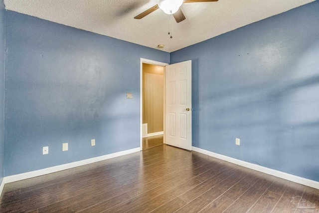 unfurnished room featuring dark hardwood / wood-style flooring, a textured ceiling, and ceiling fan