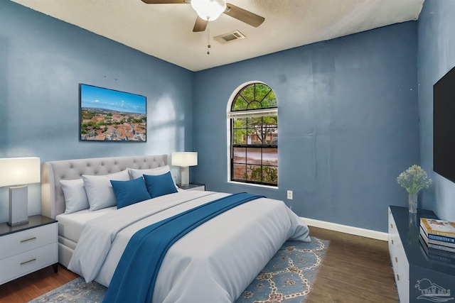 bedroom with ceiling fan and dark hardwood / wood-style floors