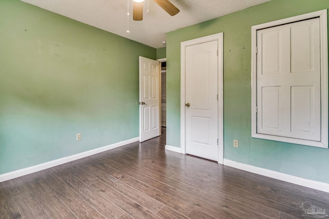 unfurnished bedroom featuring dark hardwood / wood-style floors and ceiling fan