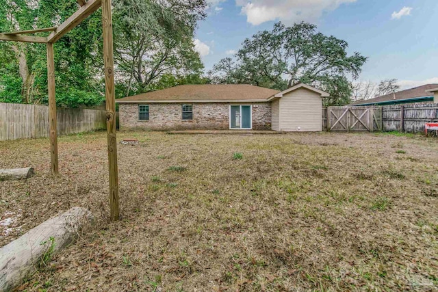 back of property with a lawn