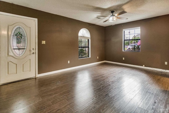 entrance foyer with dark hardwood / wood-style floors, a textured ceiling, and ceiling fan