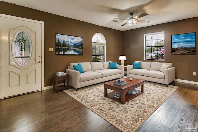 living room featuring dark hardwood / wood-style floors and ceiling fan