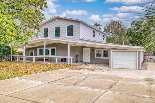 204 Camelia St, Gulf Breeze, FL 32561 - view of front of property with covered porch, an attached garage, and driveway