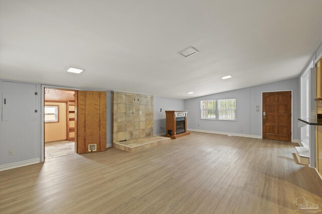 204 Camelia St, Gulf Breeze, FL 32561 - unfurnished living room with light wood-style floors, a fireplace with raised hearth, and baseboards