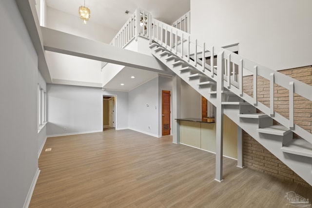 204 Camelia St, Gulf Breeze, FL 32561 - stairway featuring baseboards, wood finished floors, a high ceiling, and recessed lighting